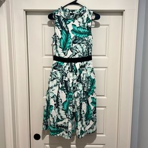 High neck dress. Below the knee. Pockets! Front has a flap - Perfect for spring.